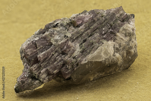 Vivid elbaite tourmaline crystals with quartz and lepidolite matrix on a contrasting yellow background, showcasing geological beauty