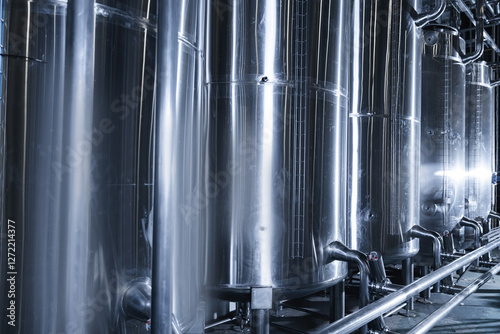 Industrial beer factory tanks and brewing equipment in modern brewery, blue tonning