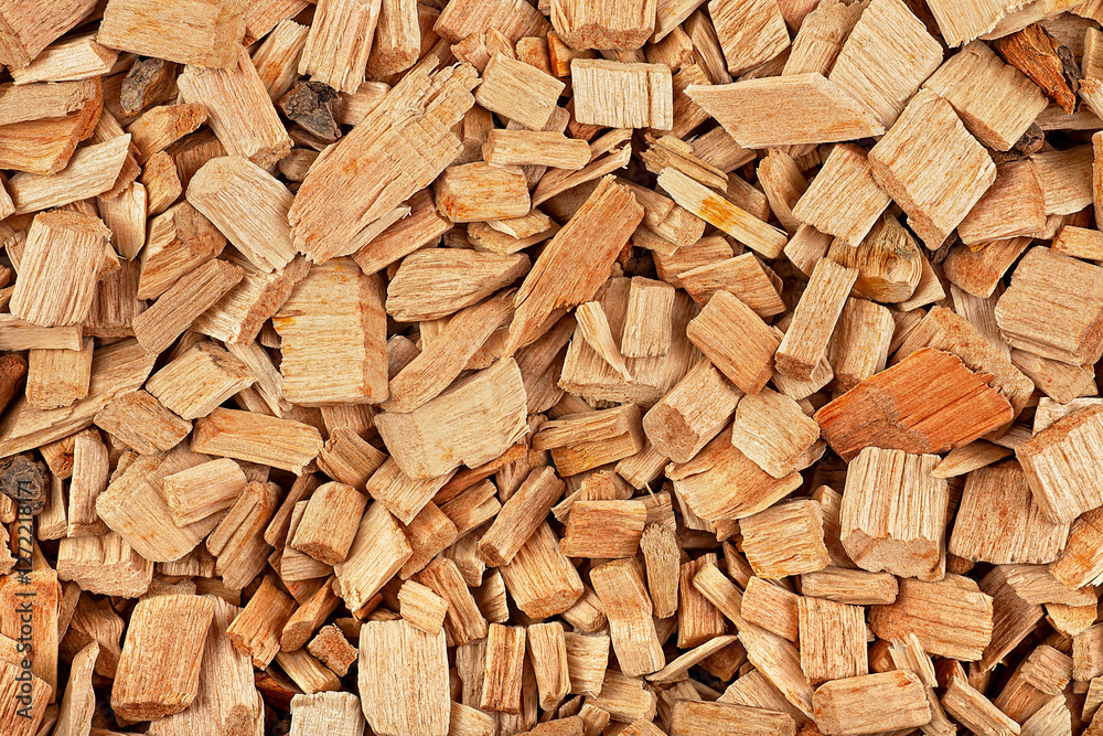 Pile of mixed wood chips as background, top view. Wood chips for smoking meat and fish. Pile of mixed wood chips as background, top view. Wood chips for smoking meat and fish.