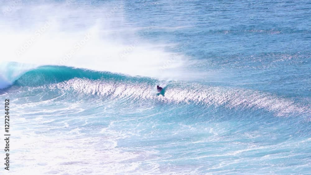 young adult surfing on a big wave in the ocean young adult surfing on a big wave in the ocean