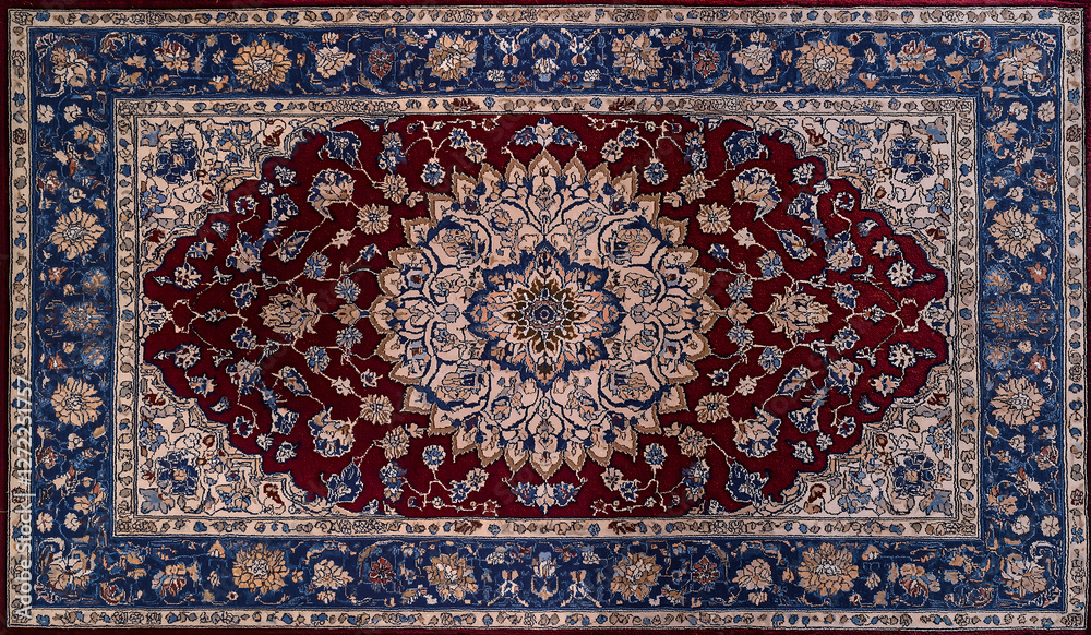 Obraz premium Luxury Persian carpet with intricate floral medallion design in red, blue and beige showcasing traditional craftsmanship and elegance