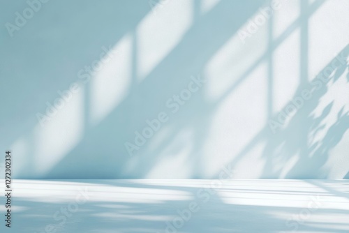 Large, empty room with a blue wall and a window