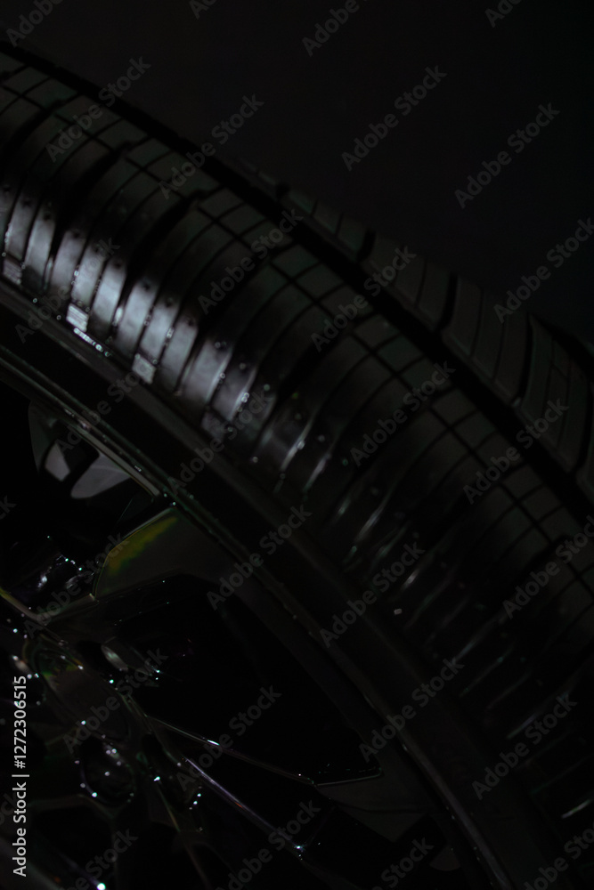 Naklejka premium car wheel on a black background