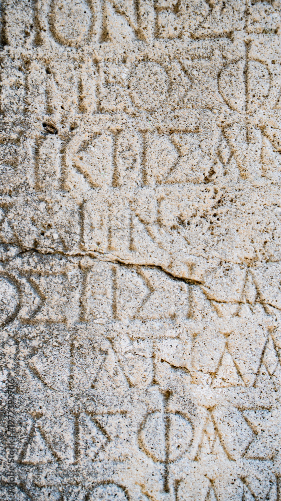 Close-up background of ancient Greek writings on the ruins of an ancient city Close-up background of ancient Greek writings on the ruins of an ancient city