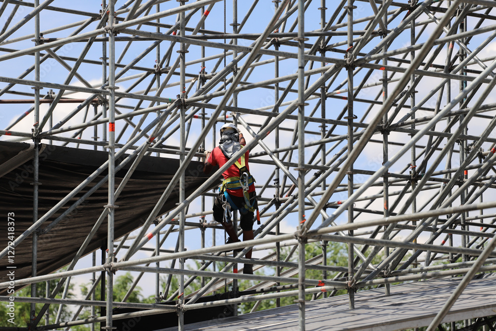 Fototapeta premium Worker assembling metal structure