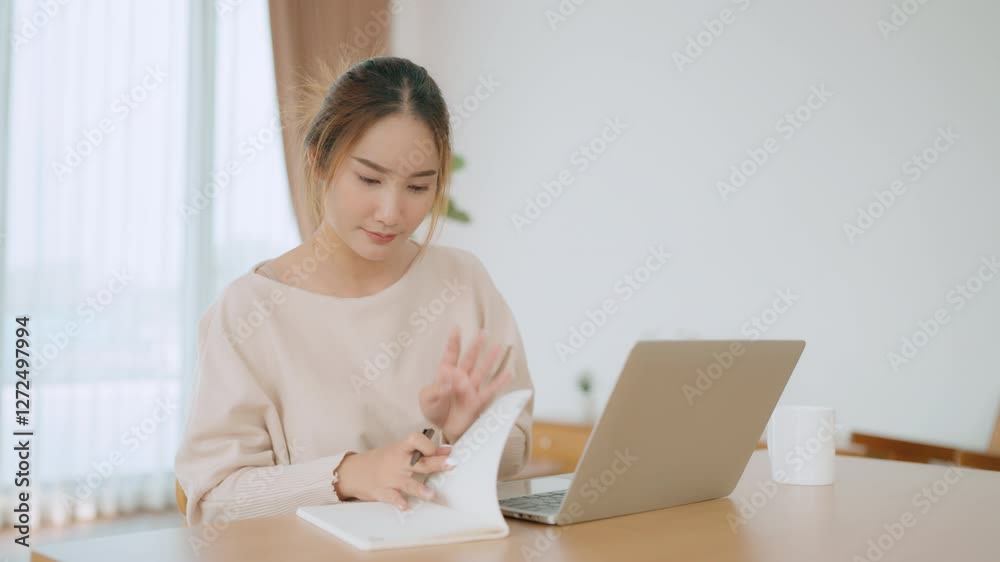 Young Asian woman happy positive cute beautiful business woman sit indoors in living room using laptop computer Young Asian woman happy positive cute beautiful business woman sit indoors in living room using laptop computer