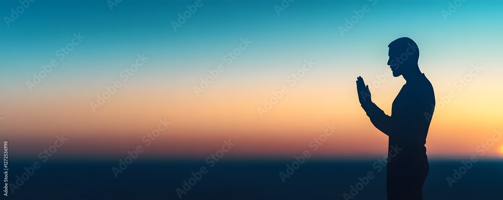 Silhouette of a man praying against a colorful gradient sunset Silhouette of a man praying against a colorful gradient sunset