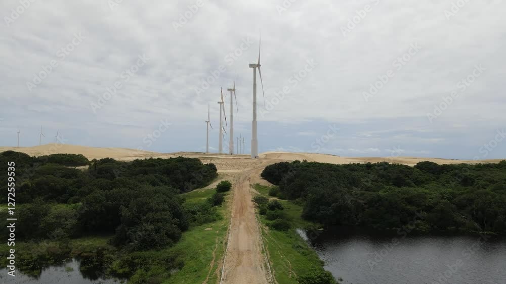 Several wind power towers seen in the background Several wind power towers seen in the background