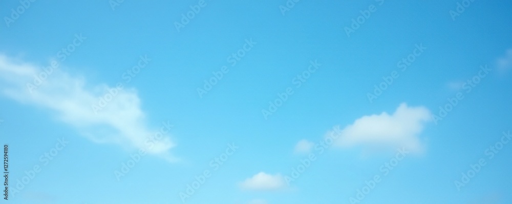 Fototapeta premium Soft focus blue sky with thin wispy white clouds against a bright blue background, blue sky, cloudy sky, atmospheric effects