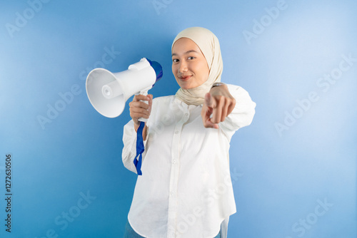 portrait of female holding megaphone smiling and pointed at the camera