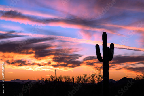 Silhouette of Saguaro Cactus Against a Vibrant Arizona Sunset with Dramatic Clouds in the Desert Sky