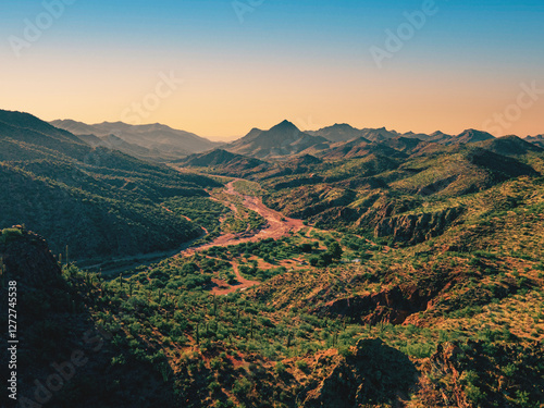 Sunrise Over a Scenic Desert Valley with Rolling Hills and Rugged Mountains in the Arizona Wilderness