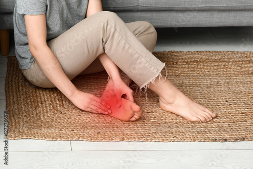 Young woman suffering from joint pain in living room photo