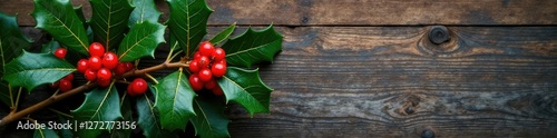 European holly branch with berries against a natural wood background, leaves, ilex, foliage