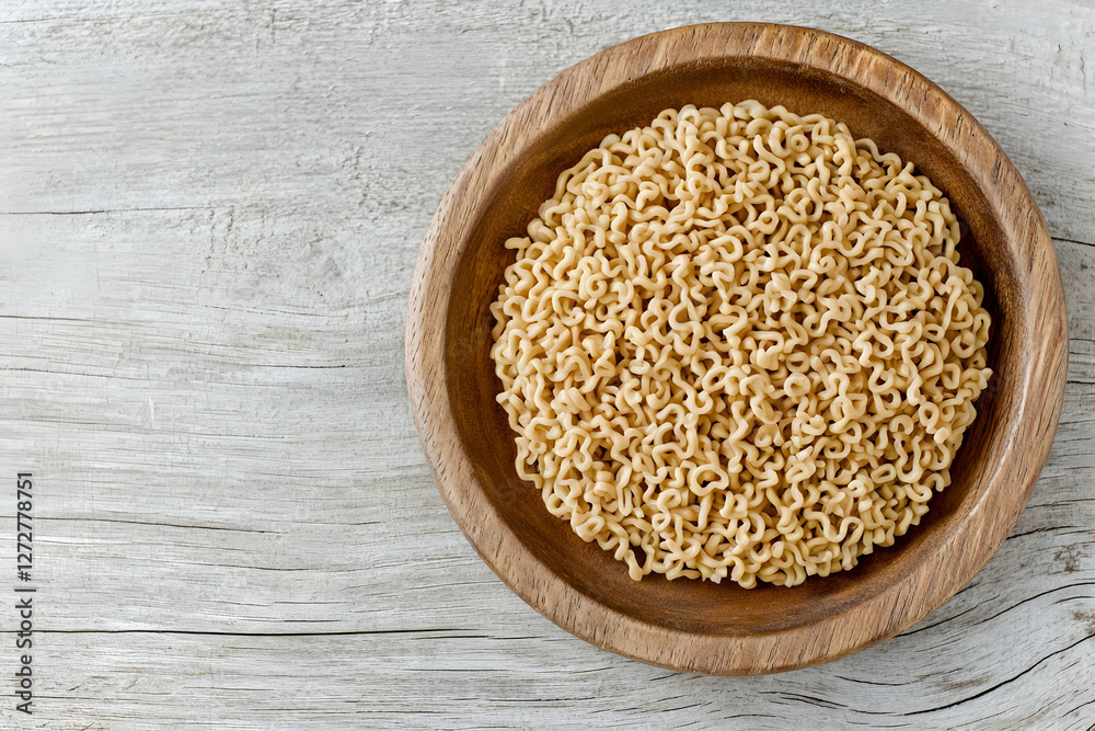 Dried noodles in wooden bowl, wood background, food prep Dried noodles in wooden bowl, wood background, food prep