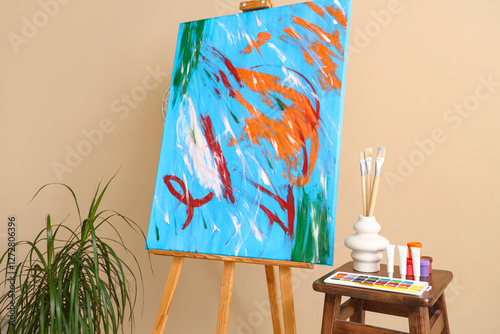 Easel with painting, housep...
