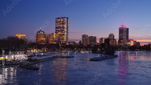 Boston city skyline with high-rise buildings seen from  Longfellow bridge over Charles river during winter sunset