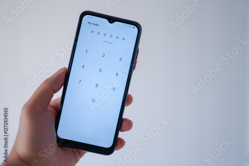 Person entering pin code to unlock the phone's screen 