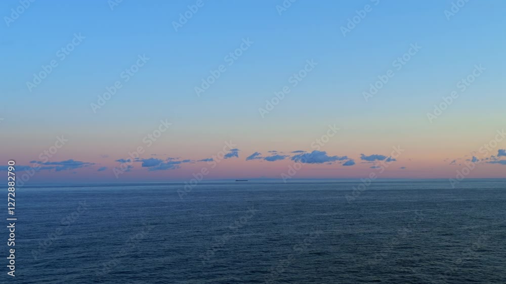 Cargo ships sail across the Mediterranean Sea at sunrise, with Mount Etna in the background. The pastel sky and calm water create a serene maritime scene with distant clouds and soft light. Cargo ships sail across the Mediterranean Sea at sunrise, with Mount Etna in the background. The pastel sky and calm water create a serene maritime scene with distant clouds and soft light.