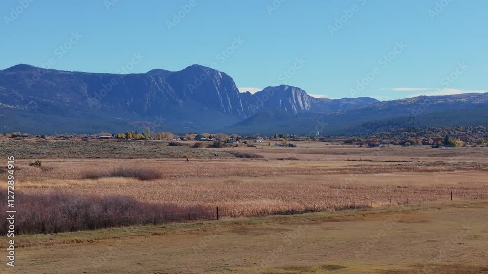 Wide scenic view of a peaceful New Mexico landscape with mountains in the background Wide scenic view of a peaceful New Mexico landscape with mountains in the background