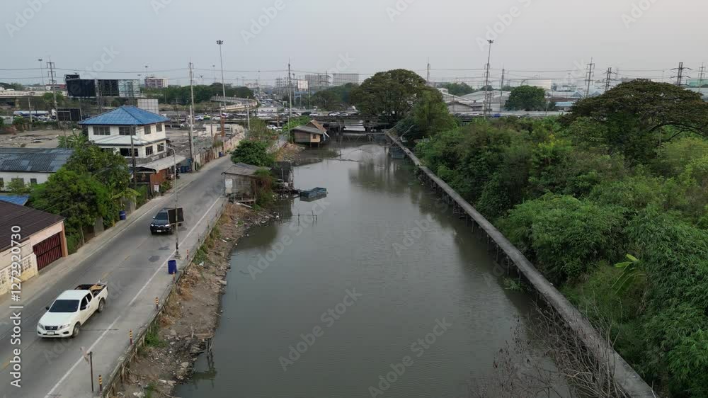 Drone shot of the Rangsit Prayunsak canal and Rangsit - Nakhon Nayok Road during daytime, Thailand Drone shot of the Rangsit Prayunsak canal and Rangsit - Nakhon Nayok Road during daytime, Thailand
