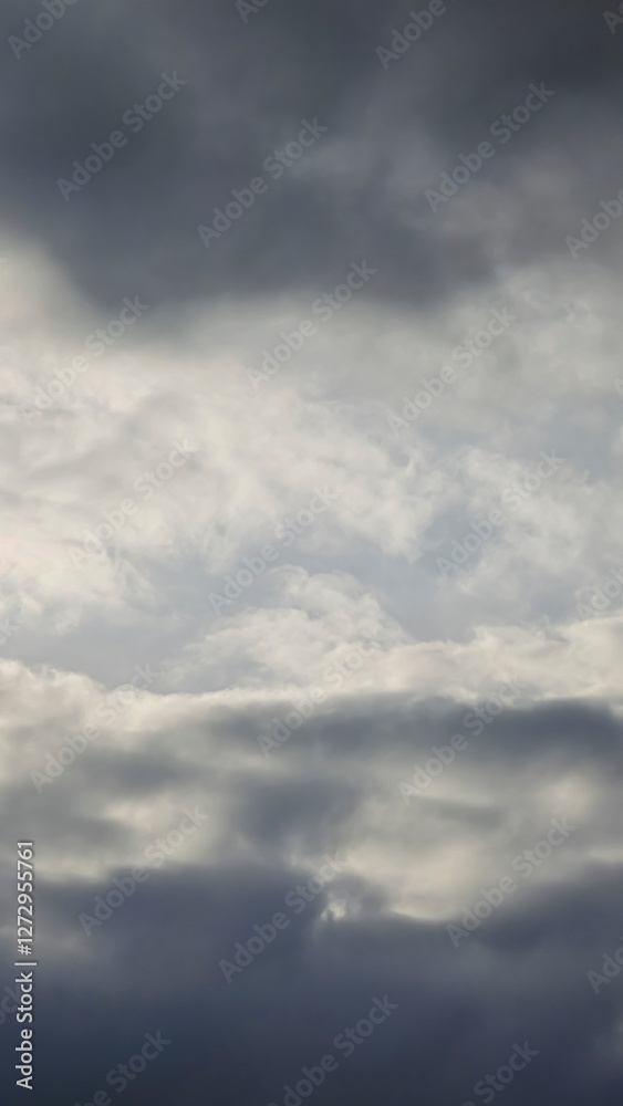 Fototapeta premium Blue sky with clouds, winter weather. Clouds on the background of trees.