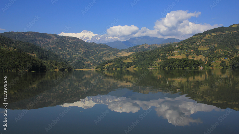 Lamjung Himal reflecting in Lake Begnas on a calm day, Nepal. Lamjung Himal reflecting in Lake Begnas on a calm day, Nepal.