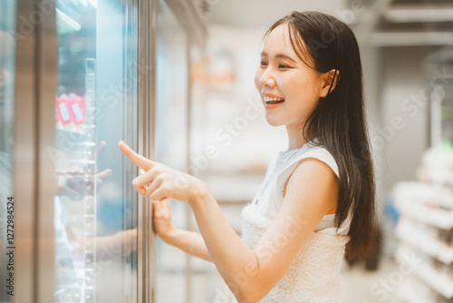 Free Download Asian woman consumer choosing food or seasoning product at supermarket store - GFXLoad