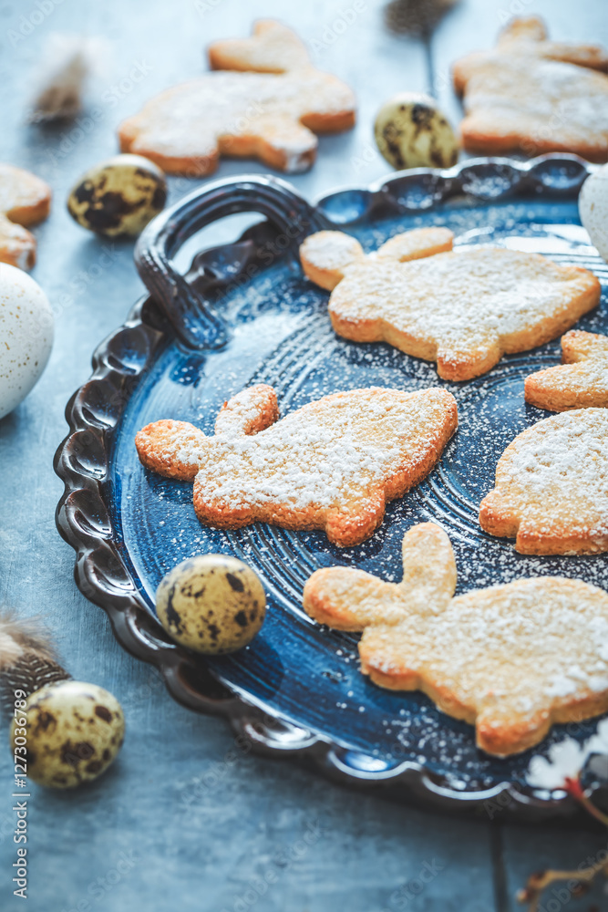 Homemade almond bunny cookies for Easter with Easter eggs in blue tone Homemade almond bunny cookies for Easter with Easter eggs in blue tone