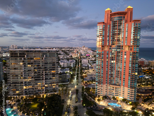 Night city aerial view. Luxury skyscraper in Miami, Florida. City skyline in evening. Aerial cityscape. Miami South beach night light. Aerial view on skyscraper cityscape at night. Residential hotel photo