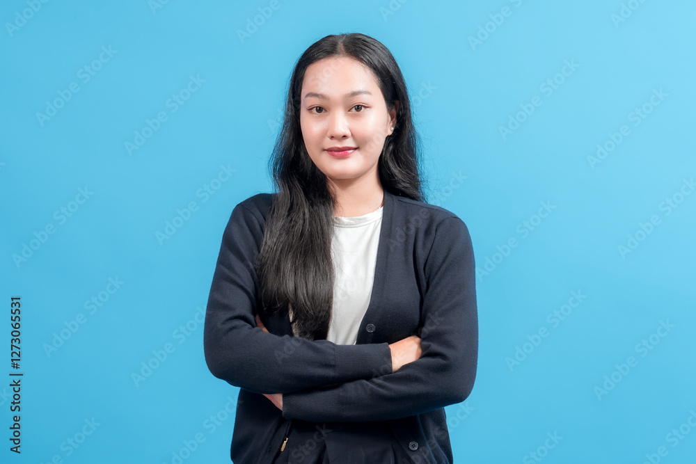 Confident young woman with arms crossed, wearing casual outfit, standing against bright blue background. Perfect for business, lifestyle, self-assurance, positivity, and personal branding concepts. Confident young woman with arms crossed, wearing casual outfit, standing against bright blue background. Perfect for business, lifestyle, self-assurance, positivity, and personal branding concepts.