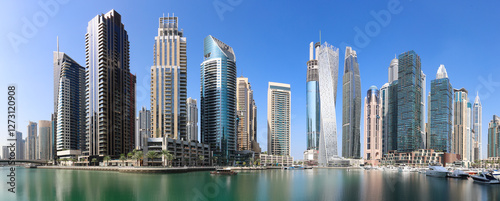 Photography Dubai Marina at day with boat and blue sky, UAE