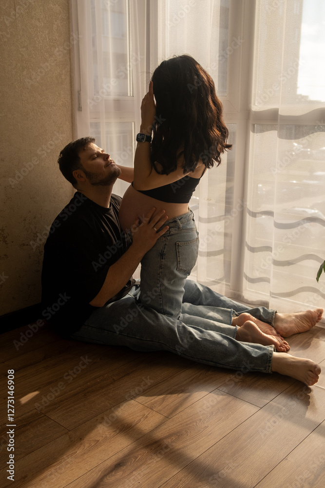 Intimate Moment of Expecting Parents by the Window