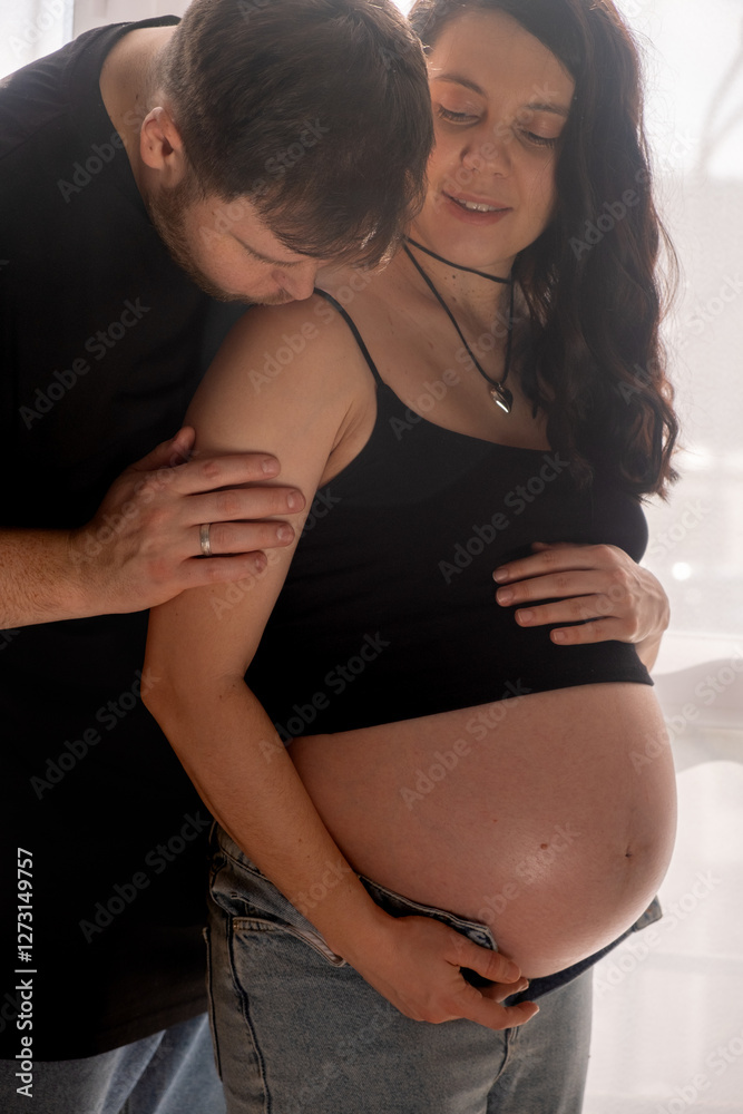 Intimate Moment of Expecting Parents by the Window