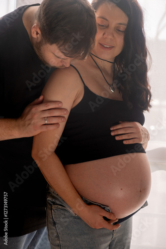 Intimate Moment of Expecting Parents by the Window