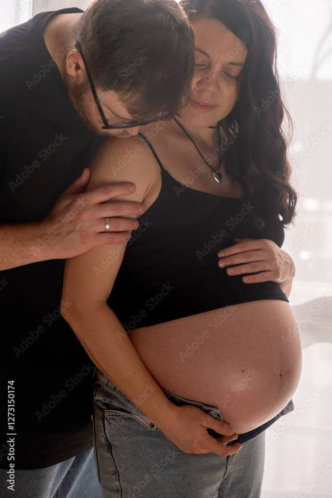 Intimate Moment of Expecting Parents by the Window