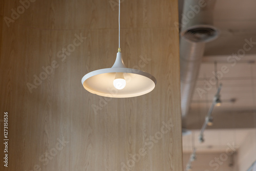 Фотография A white light fixture hanging from the ceiling