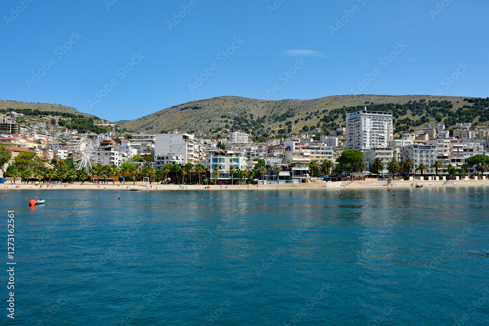 Obraz premium Sarande on the Ionian coastline of southern Albania, part of the Albanian Riviera. Here, the hills of the Ceraunian mountain range meet the Straits of Corfu in the eastern Mediterranean Sea