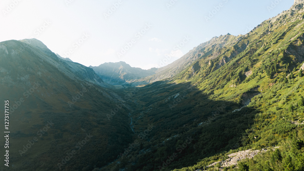 Breathtaking sunset over the Barguzin Mountains, casting golden hues across the rugged peaks and creating a stunning natural spectacle. Breathtaking sunset over the Barguzin Mountains, casting golden hues across the rugged peaks and creating a stunning natural spectacle.