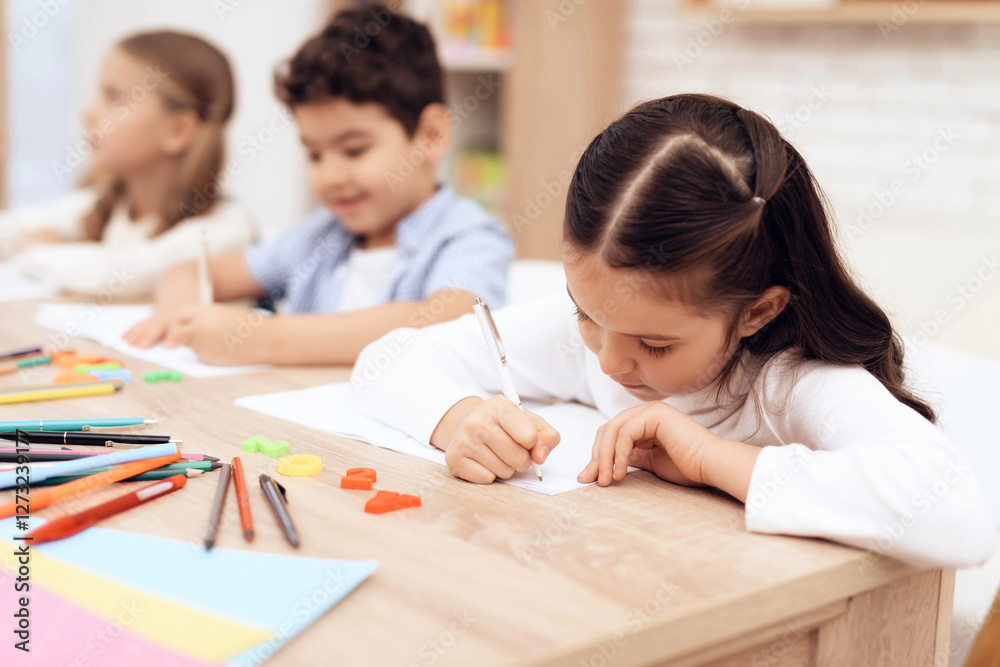 Children write in notebooks with a pen. Children write in notebooks with a pen.