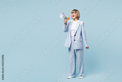 Full body employee business woman 50s wear classic suit glasses formal clothes hold in hand megaphone scream announces discounts sale Hurry up isolated on plain blue background Lifestyle work concept photo