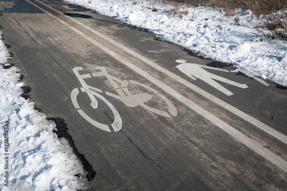Road markings with separate lanes for pedestrians and bicycles. Winter conditions.