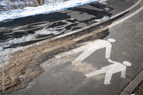 Obraz na płótnie Road markings with separate lanes for pedestrians and bicycles. Winter conditions.
w salonie