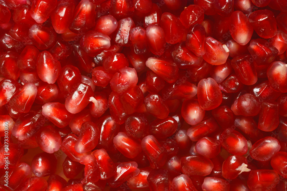 A close-up shot of pomegranate arils, showcasing their vibrant red color and juicy texture A close-up shot of pomegranate arils, showcasing their vibrant red color and juicy texture