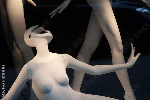 Mannequins in a display. Artificial figures, retail, and a sense of form.