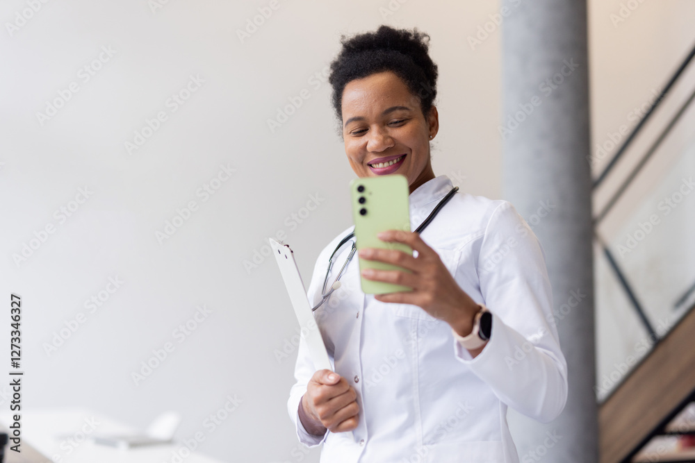 Experienced African American doctor entering data on a digital device Experienced African American doctor entering data on a digital device
