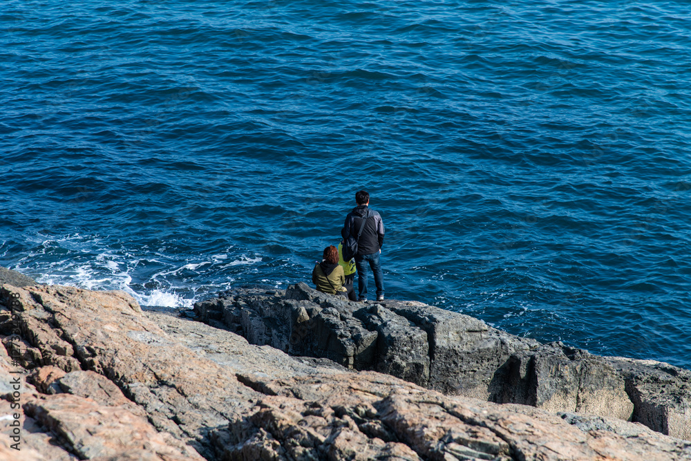 high-angle view of the tourist on the cliff at the seaside high-angle view of the tourist on the cliff at the seaside