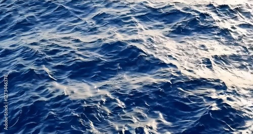 Slow motion close up of disturbed blue ocean water surface