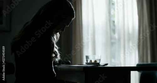 A depression woman sits alone at the table