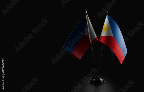 Small national flags of the Philippines on a black background photo